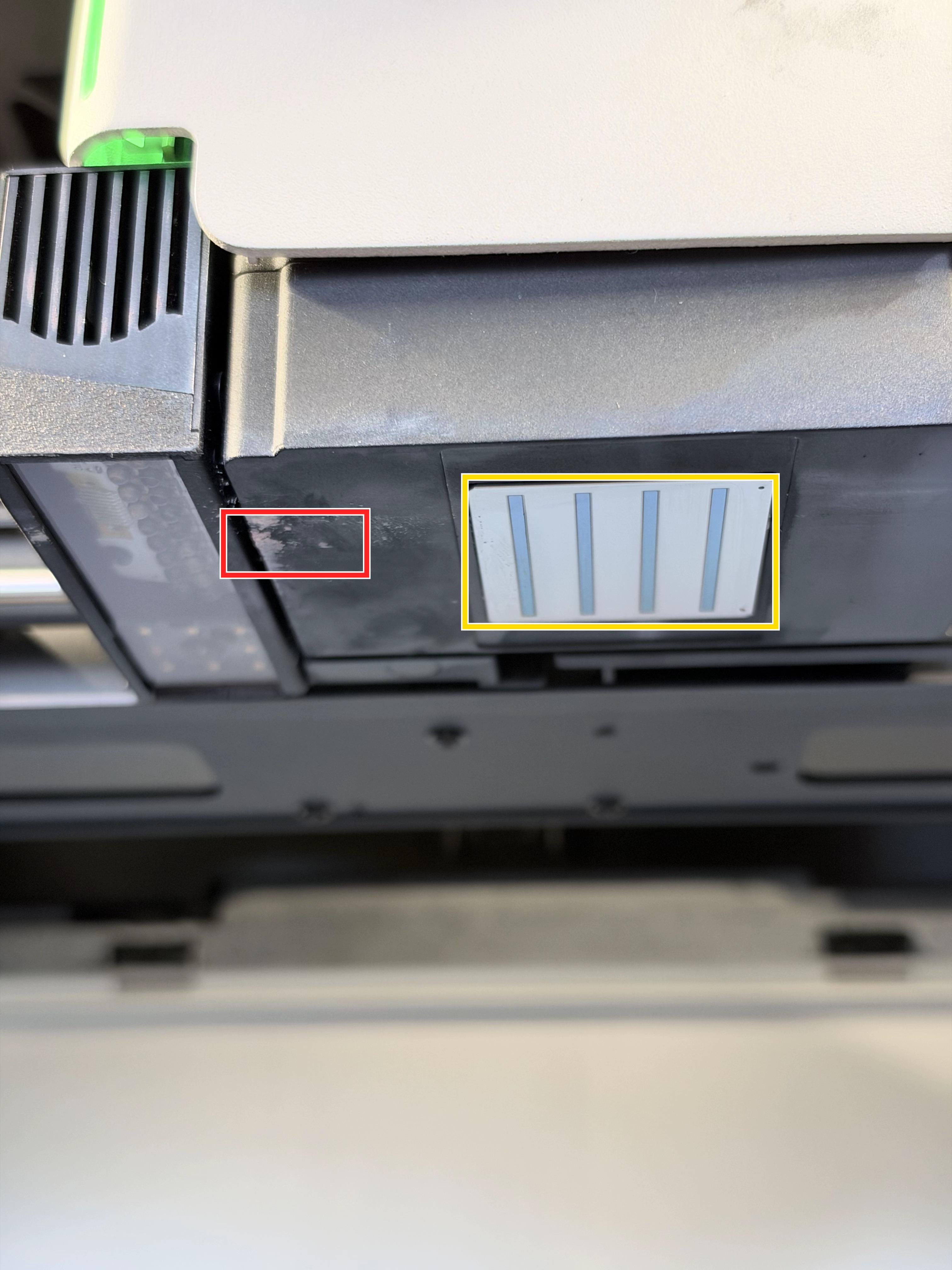 Printhead showing an example of cured ink residue and the nozzle area